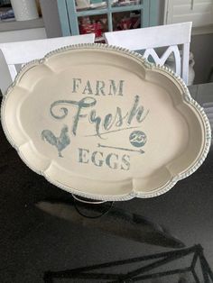 a farm fresh egg tray sitting on top of a table next to a white chair