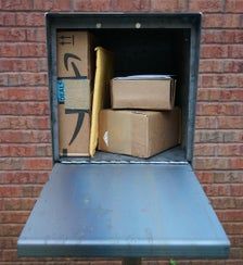 boxes are stacked in the back of an open box on top of a metal table