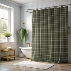 a bathroom with a tub, sink and shower curtain in green checkered fabric next to a window