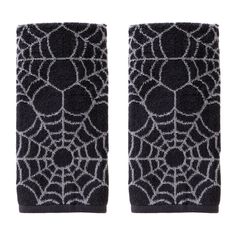 two pairs of black and white spider web wrist warmers, one with grey dots on it