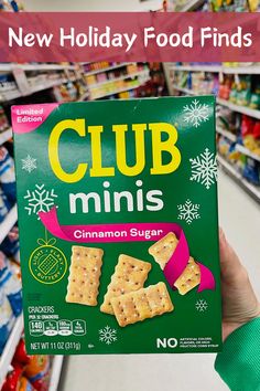 a person holding up a box of club minis in a grocery store with the text new holiday food finds