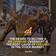 a man standing in front of a bull statue