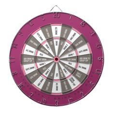 a pink and grey dart board with words on it