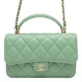 a green chanel bag with chain handles