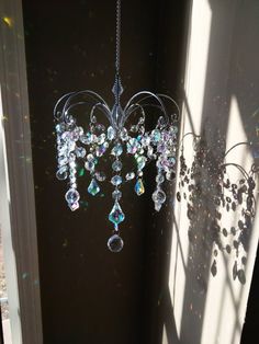 a chandelier hanging from the side of a window