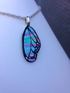 a necklace with a butterfly wing on it