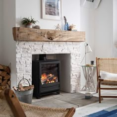 a living room with a fire place and wicker chairs next to an open fireplace