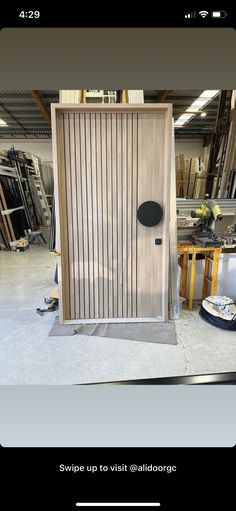 a wooden door in the middle of a room with tools and other items around it