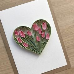 a heart shaped card with pink flowers on it