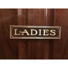 a door sign that says ladies on it