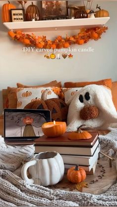 a bed with pumpkins and books on it