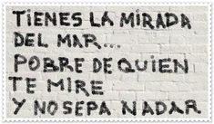 a stamp with the words written on it in spanish and english, against a white brick wall