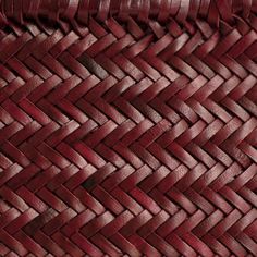 a close up view of a red woven basket