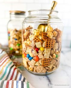 a glass jar filled with cheetos and cereal