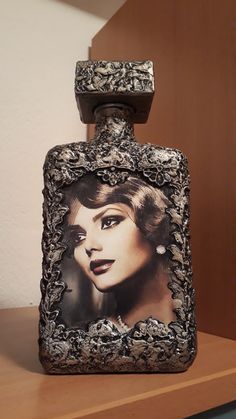 a bottle with a picture of a woman in it on top of a wooden shelf