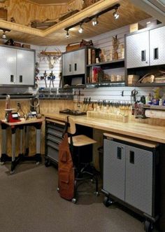 a kitchen with lots of workbenches and cabinets