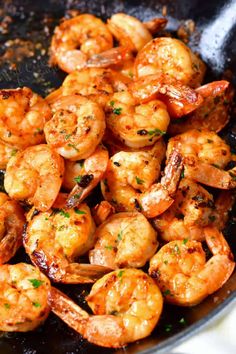 cooked shrimp in a skillet with garlic and parsley on the side, ready to be served