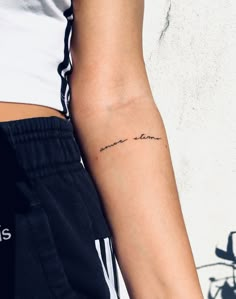 a woman's arm with a small tattoo that reads, i love you on it