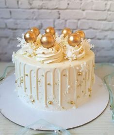 a white cake with gold decorations on top