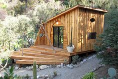 a small wooden building with steps leading up to it