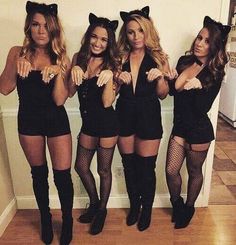 four beautiful women dressed in cat costumes posing for the camera with their hands on their hips