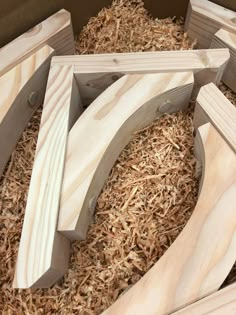 several pieces of wood sitting on top of some shredded up wood shavings in a box