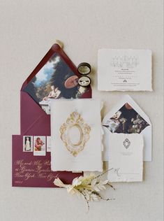 the wedding stationery is laid out on top of each other, including an envelope and some cards