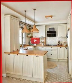 a kitchen with white cabinets and wooden counter tops