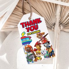 a tag that says thank you for coming with some cartoon characters hanging from the ceiling