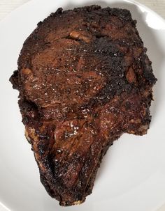 a piece of steak on a white plate