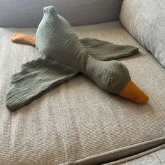 a stuffed bird sitting on top of a couch