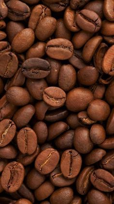 coffee beans are piled on top of each other