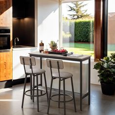 three stools sit at the bar in this modern kitchen