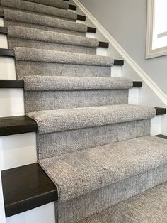 a carpeted staircase leading up to the second floor