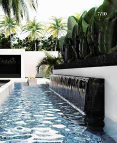 an outdoor swimming pool surrounded by palm trees and water features blue tiles on the floor