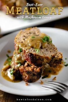 meatloaf with mushroom gravy on a white plate next to a fork