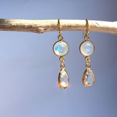 A Small Faceted Moonstone And A Crystal Clear Glass Droplet Hang Together. This Dainty Duo Is Subtle And Yet Still Catches Your Eye As The Mystic Moonstone Changes Color In The Light. 14k Over Sterling Silver Ear Wires And Gemstone Bezel, Gold Plated Bezel. Approx. Size: 1.5"L, 3/8"W Handmade Earrings By Jpeace Designs *Gemstones Are Natural And No Two Are Alike. Shape And Color Variations Are What Give Them Each Character. Magical Moonstone: Promotes Positive Well-Being And Balance. Moonstone Earrings Dangle, Faberge Jewelry, Moonstone Crystal, Moonstone Earrings, Moonstone Jewelry, Crystal Drop Earrings, Crystal Drop, Moon Stone, Handmade Earrings