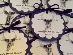 purple and white tags with charms on them for bride's bridal shower favors