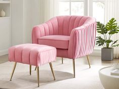 a pink chair and ottoman in a living room