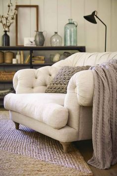 a white couch sitting on top of a rug in a living room