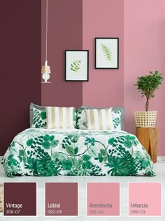 a bedroom with pink walls and green leaves on the bed