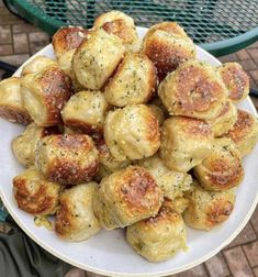 a white plate topped with meatballs covered in cheese