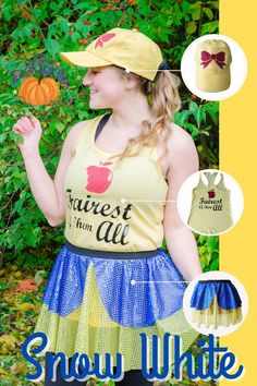 a woman wearing a yellow shirt and blue skirt with an apple on it, while standing in