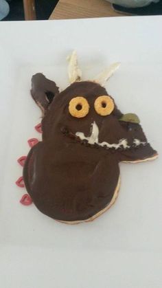 a decorated cookie with chocolate icing and eyes