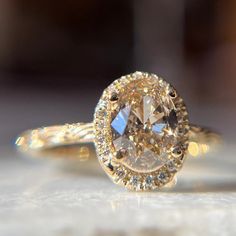 a close up view of a fancy ring with an oval cut diamond in the center