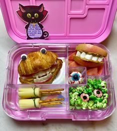 a pink lunch box filled with lots of food