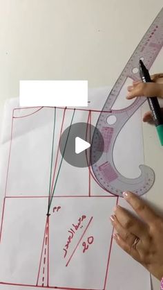 someone is cutting out a pattern with a ruler