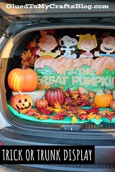 trunk or trunk display with pumpkins and jack - o'- lanterns in the trunk