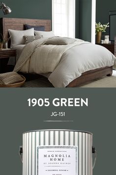 the paint colors in this bedroom are light blue, dark green and white with silver accents