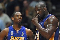 two basketball players standing next to each other